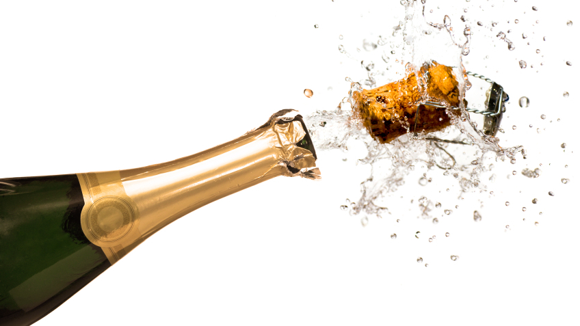 Close-up of explosion of champagne bottle cork