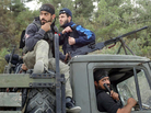 Rebels of the Free Syrian Army sit on top of a military truck captured from the Syrian army in the village of Khirbet al-Joz along the Turkish border in northern Syria on Oct. 7, in this photo provided by the Edlib News Network, ENN. The rebels hope to put a civilian council in charge and believe such moves could help pave the way for a secular, democratic Syria. Rebels of the Free Syrian Army sit on top of a military truck captured from the Syrian army in the village of Khirbet al-Joz along the Turkish border in northern Syria on Oct. 7, in this photo provided by the Edlib News Network, ENN. The rebels hope to put a civilian council in charge and believe such moves could help pave the way for a secular, democratic Syria.