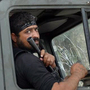 Rebels of the Free Syrian Army sit on top of a military truck captured from the Syrian army in the village of Khirbet al-Joz along the Turkish border in northern Syria on Oct. 7, in this photo provided by the Edlib News Network, ENN. The rebels hope to put a civilian council in charge and believe such moves could help pave the way for a secular, democratic Syria.
