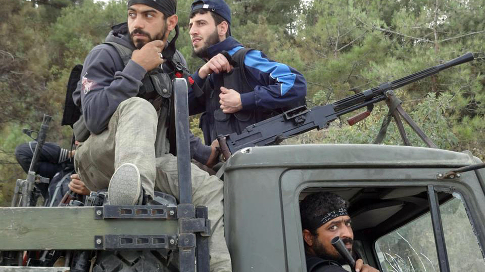 Rebels of the Free Syrian Army sit on top of a military truck captured from the Syrian army in the village of Khirbet al-Joz along the Turkish border in northern Syria on Oct. 7, in this photo provided by the Edlib News Network, ENN. The rebels hope to put a civilian council in charge and believe such moves could help pave the way for a secular, democratic Syria.