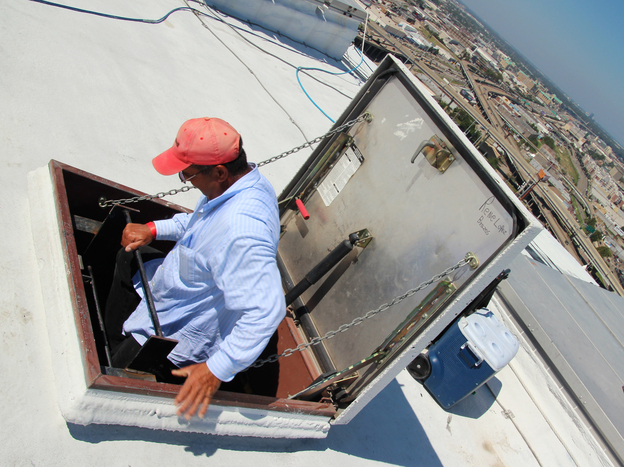 As the roofers get to the top, they literally straddle the void, swinging their bodies from the ladder to the roof over a small but frightening gap.