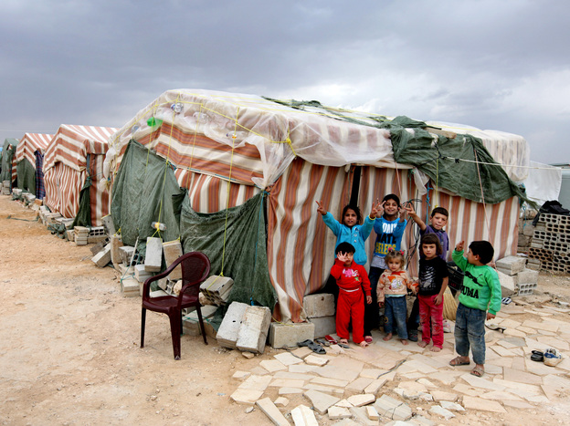 Syrian children flash victory signs Oct. 2 as they stand in front of their tents at a refugee camp in Arsal, a Sunni Muslim town in eastern Lebanon near the Syrian border. The town has become a safe haven for war-weary Syrian rebels.