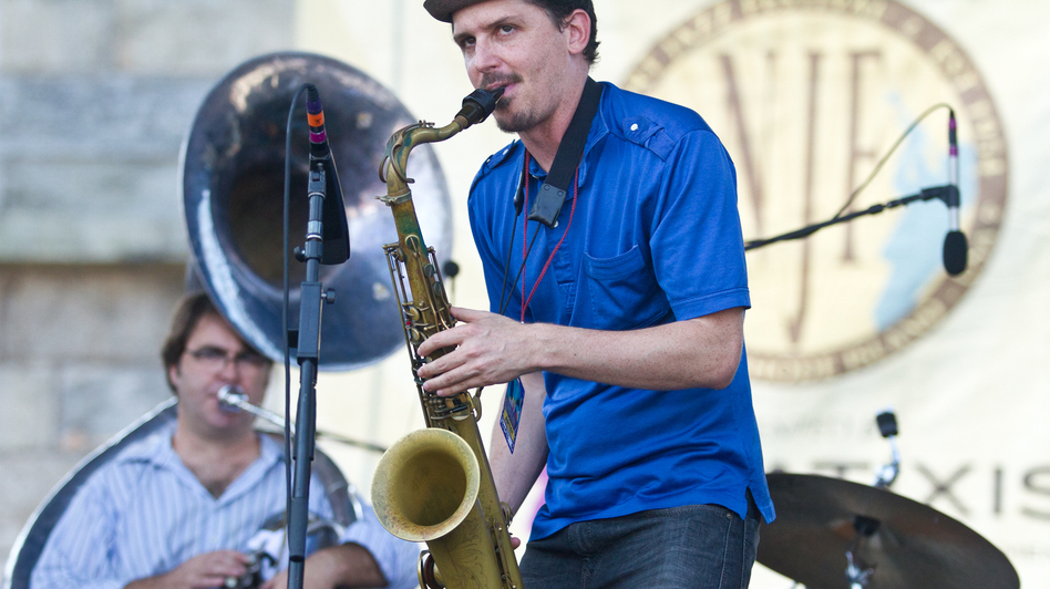 Saxophonist John Ellis (center) performs with Matt Perrine (left) on sousaphone at the 2012 Newport Jazz Festival.