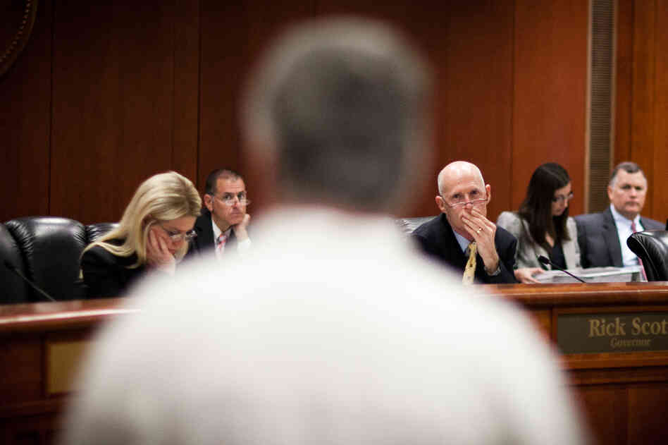 Florida Gov. Rick Scott listens to testimony from felons attempting to restore their right to vote at a clemency hearing in Tallahassee, Fla., in June. Florida Gov. Rick Scott listens to testimony from felons attempting to restore their right to vote at a clemency hearing in Tallahassee, Fla., in June.