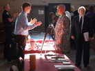 Sgt. Ben Roberts (center), recently returned from Afghanistan, speaks with Chick-fil-A manager Michael Sims at a military job fair in Columbia, S.C., in January. Sgt. Ben Roberts (center), recently returned from Afghanistan, speaks with Chick-fil-A manager Michael Sims at a military job fair in Columbia, S.C., in January.