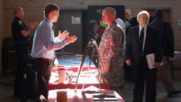 Sgt. Ben Roberts (center), recently returned from Afghanistan, speaks with Chick-fil-A manager Michael Sims at a military job fair in Columbia, S.C., in January.