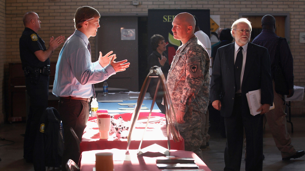 Sgt. Ben Roberts (center), recently returned from Afghanistan, speaks with Chick-fil-A manager Michael Sims at a military job fair in Columbia, S.C., in January.