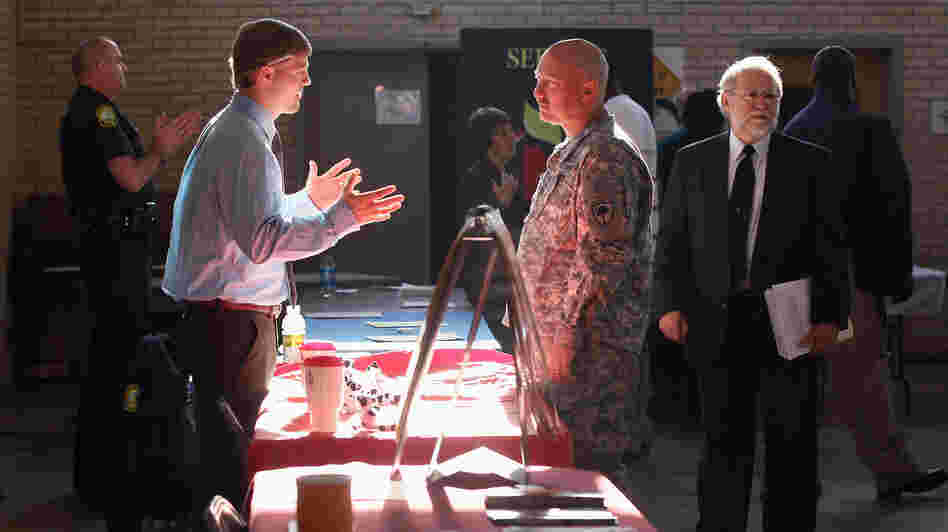Sgt. Ben Roberts (center), recently returned from Afghanistan, speaks with Chick-fil-A manager Michael Sims at a military job fair in Columbia, S.C., in January.