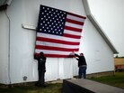 Aides tack up an American flag to a barn at the James Koch farm in Van Meter, Iowa, on Oct. 9, ahead of Republican presidential candidate Mitt Romney's arrival for a rally. Aides tack up an American flag to a barn at the James Koch farm in Van Meter, Iowa, on Oct. 9, ahead of Republican presidential candidate Mitt Romney's arrival for a rally.