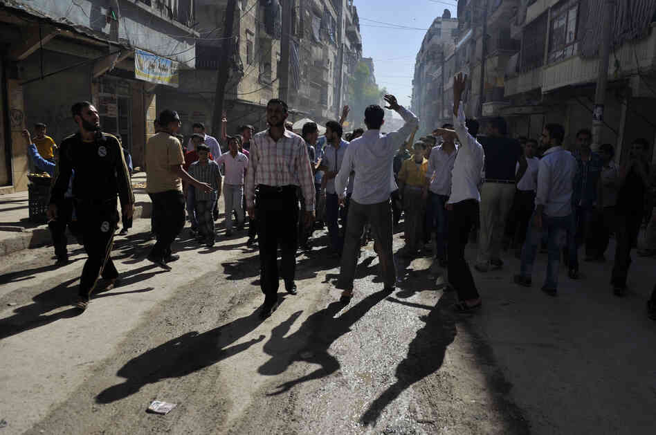 Syrian protesters shout slogans during an anti-regime demonstration in the northern city of Aleppo on Friday.