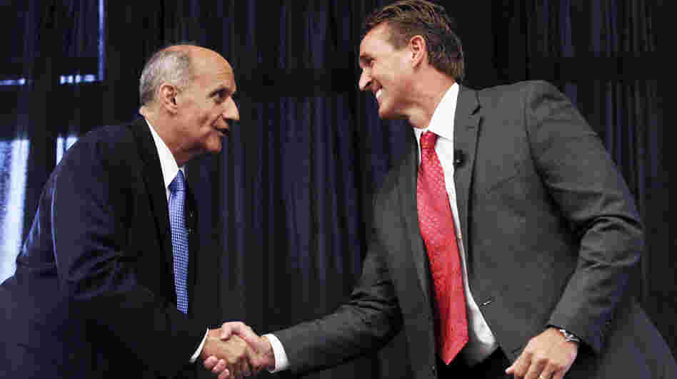 Democrat Richard Carmona (left) and Republican Rep. Jeff Flake shake hands before Thursday's debate in Chandler, Ariz.