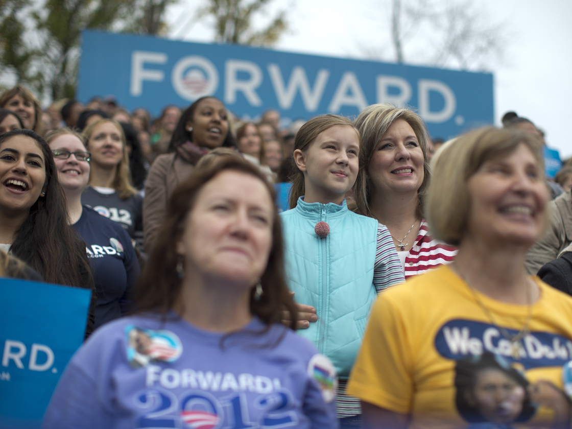 Onlookers listen as President Obama speaks Friday in Fairfax, Va., about the choice facing women in the election.