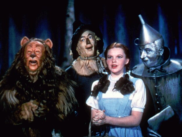 Bert Lahr as the Cowardly Lion, Ray Bolger as the Scarecrow, Judy Garland as Dorothy, and Jack Haley as the Tin Man in The Wizard Of Oz.