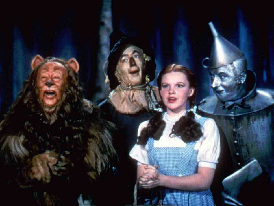 Bert Lahr as the Cowardly Lion, Ray Bolger as the Scarecrow, Judy Garland as Dorothy, and Jack Haley as the Tin Man in The Wizard Of Oz.