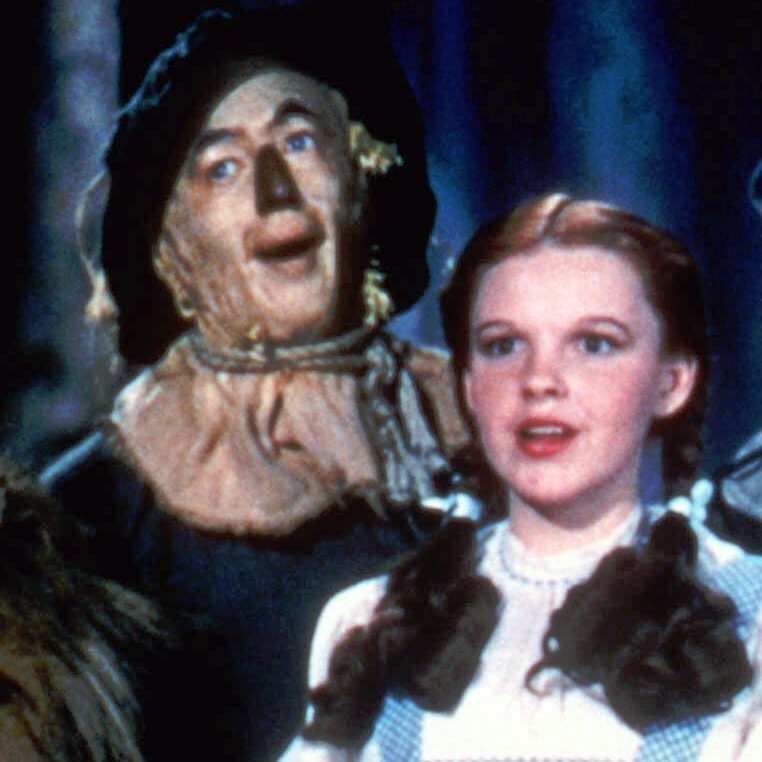 Bert Lahr as the Cowardly Lion, Ray Bolger as the Scarecrow, Judy Garland as Dorothy, and Jack Haley as the Tin Man in The Wizard Of Oz.