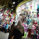 Nighttime shoppers pause to look at a display at Cairo's Ataba market in May 2011. The government says shops must close earlier in order to save scarce electricity, but many Cairo residents are complaining.