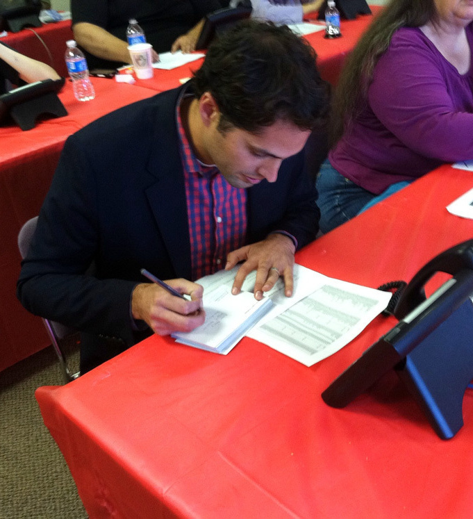 Craig Romney, the son of Republican presidential candidate Mitt Romney, signs postcards to voters at a campaign office in Aurora, Colo. Craig Romney, the son of Republican presidential candidate Mitt Romney, signs postcards to voters at a campaign office in Aurora, Colo.
