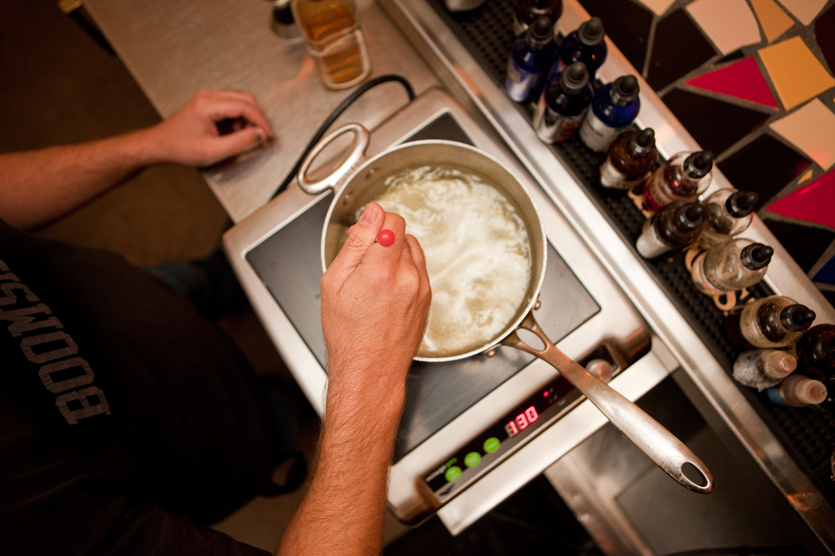 Berner stirs the oil into the simmering gin, and cooks and stirs for about 20 minutes. Berner stirs the oil into the simmering gin, and cooks and stirs for about 20 minutes.
