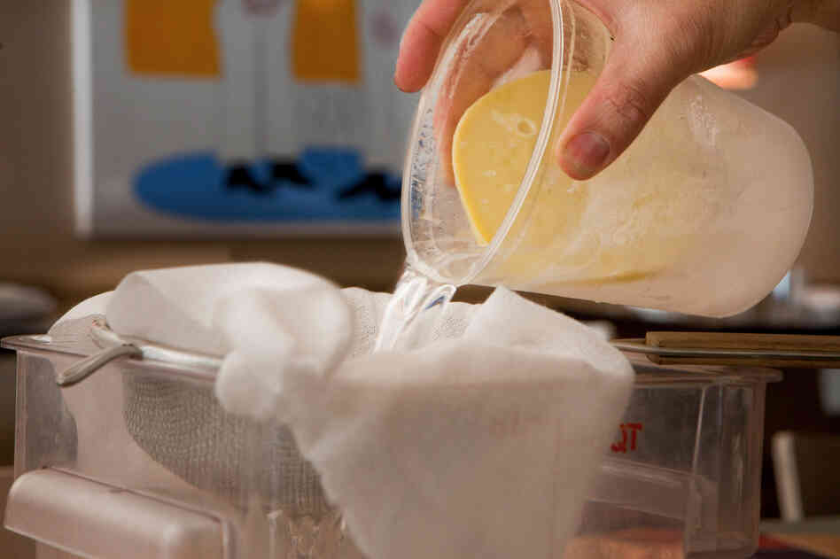The next day, Berner pulls the mixture from the freezer and strains it in a sieve lined with cheesecloth, leaving the fat behind.