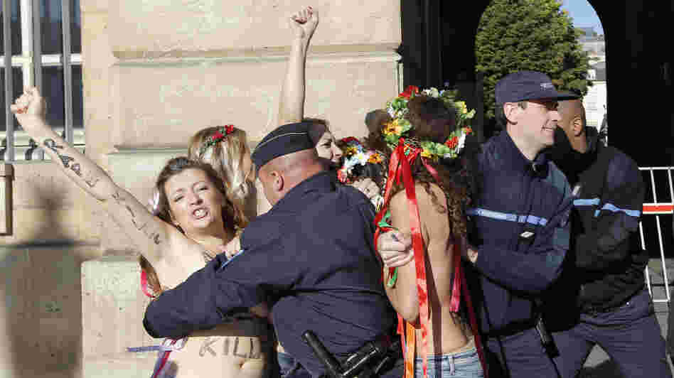 French policemen on Oct. 15 detain topless activists from the group Femen who are protesting the verdict in a gang rape trial. The group was established in Ukraine but is now setting up an office in Paris. French policemen on Oct. 15 detain topless activists from the group Femen who are protesting the verdict in a gang rape trial. The group was established in Ukraine but is now setting up an office in Paris.