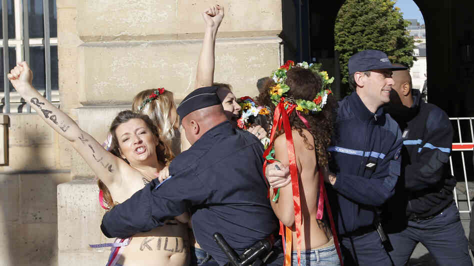 French policemen on Oct. 15 detain topless activists from the group Femen who are protesting the verdict in a gang rape trial. The group was established in Ukraine but is now setting up an office in Paris. French policemen on Oct. 15 detain topless activists from the group Femen who are protesting the verdict in a gang rape trial. The group was established in Ukraine but is now setting up an office in Paris.