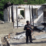 Pakistani security personnel stand guard in front of a burnt-out school following an attack by the Pakistani Taliban in the northwestern district of Upper Dir in June 2011. The Taliban have destroyed many schools in northwestern Pakistan.