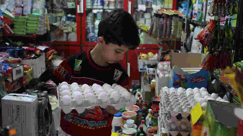 An Iranian boy holds a tray of eggs at a grocery store in Tehran last month. From Sunday, Sept. 30, to Monday, Oct. 1, the Iranian currency lost nearly one-third of its value against the dollar. An Iranian boy holds a tray of eggs at a grocery store in Tehran last month. From Sunday, Sept. 30, to Monday, Oct. 1, the Iranian currency lost nearly one-third of its value against the dollar.