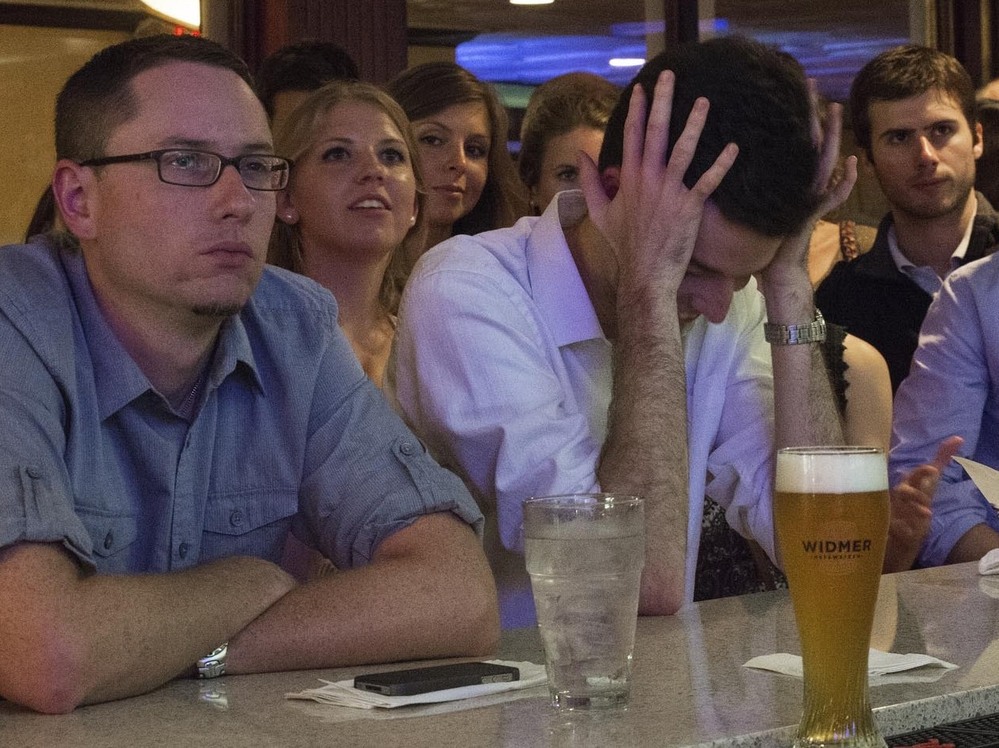 Bar patrons watch the Oct. 3 presidential debate at Bullfeathers, a bar a short distance from the U.S. Capitol. Drinking and debate-watching often go hand in hand — to the point where drinking games have been developed around watching the debates.