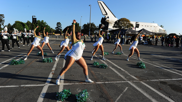 Inglewood High School cheerleaders perform in front of the Space Shuttle Endeavour as it is transported through the streets of Inglewood and Los Angeles on October 13.
