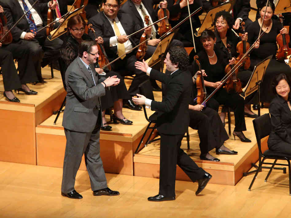 Composer Steven Stucky is warmly greeted by Dudamel after the performance of his newly written Symphony.
