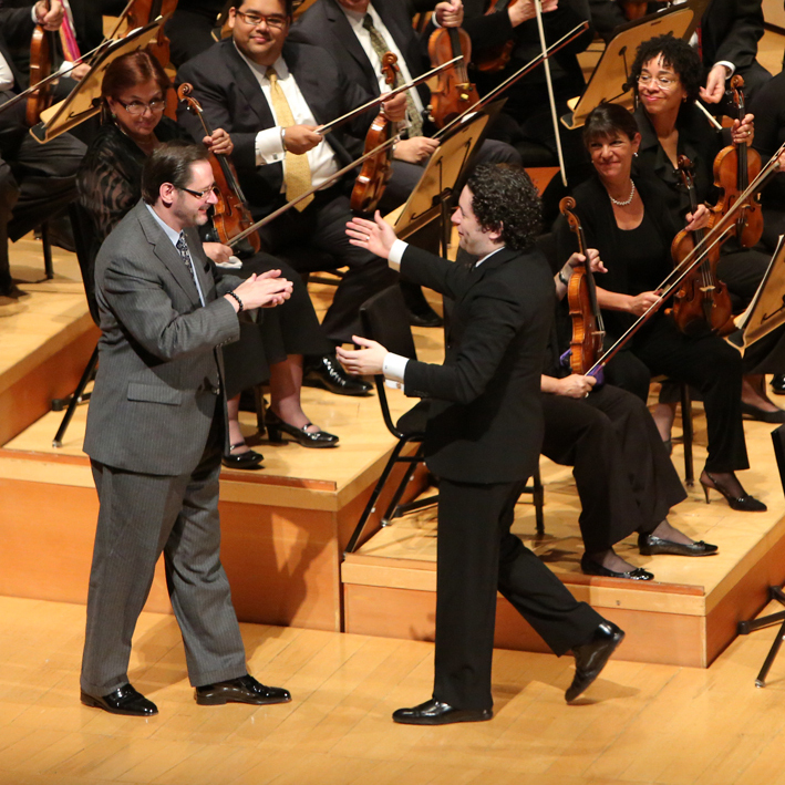Composer Steven Stucky is warmly greeted by Dudamel after the performance of his newly written Symphony.