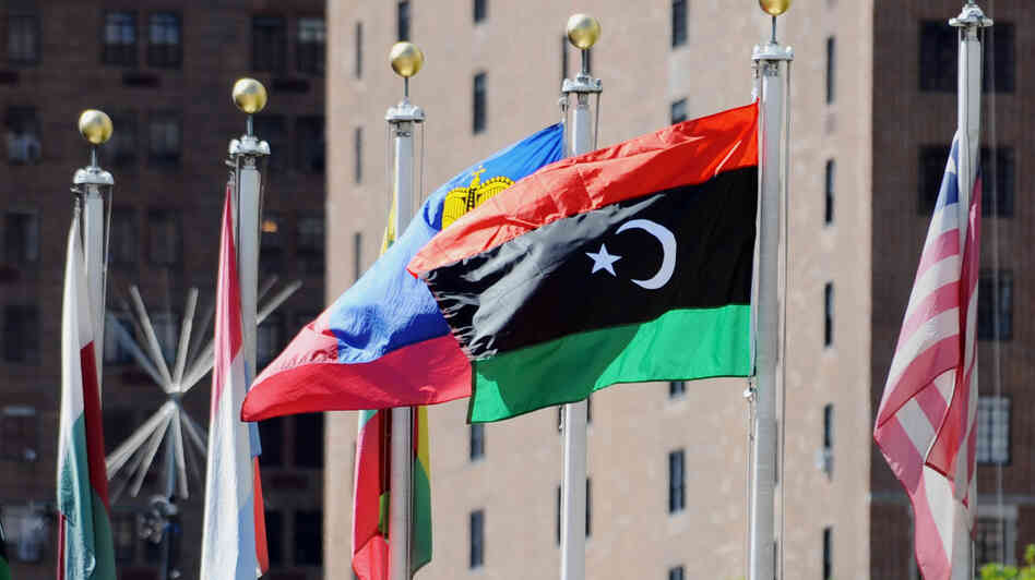 The flag of Libya's National Transitional Council (second from right) flies outside the United Nations headquarters building in New York.