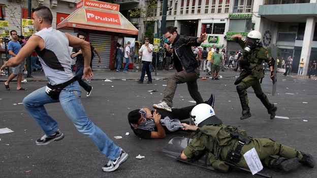 Demonstrators clash with riot police in Athens while protesting the visit of German Chancellor Angela Merkel on Oct. 9. The euro crisis is one of several issues that came up little, if at all, during the U.S. presidential debates.