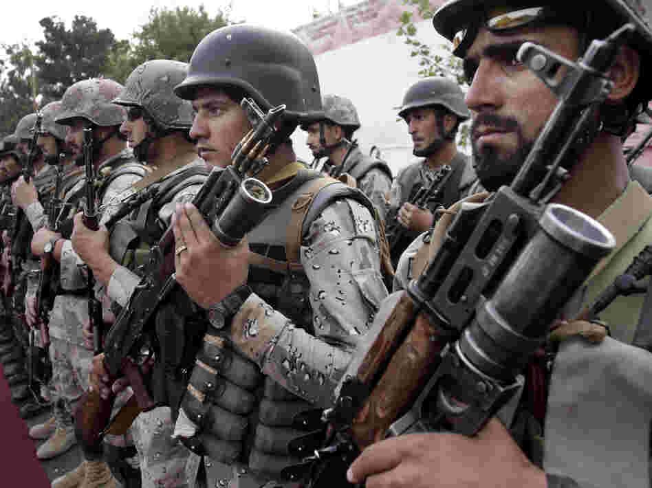 Afghan soldiers stand at attention during a ceremony transferring authority from NATO-led troops to Afghan security forces in Afghanistan's Kunar province. The transfer of responsibility for security from NATO-led ISAF forces to Afghan troops is scheduled to be completed by the end of 2014.