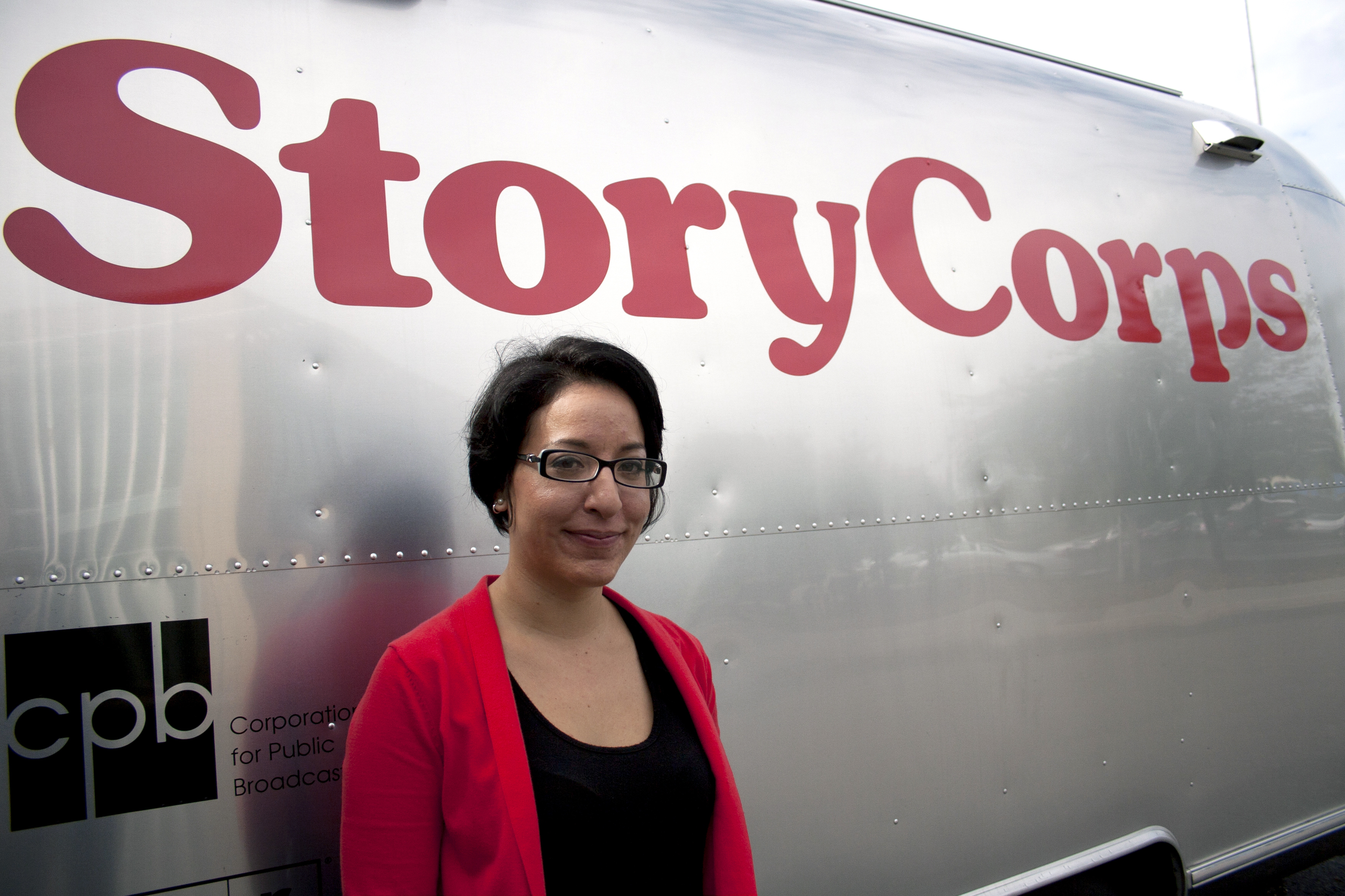StoryCorps facilitator Virginia Lora stands next to the MobileBooth trailer parked outside the Columbia Pike Branch Library and Career Center in Arlington, Va.