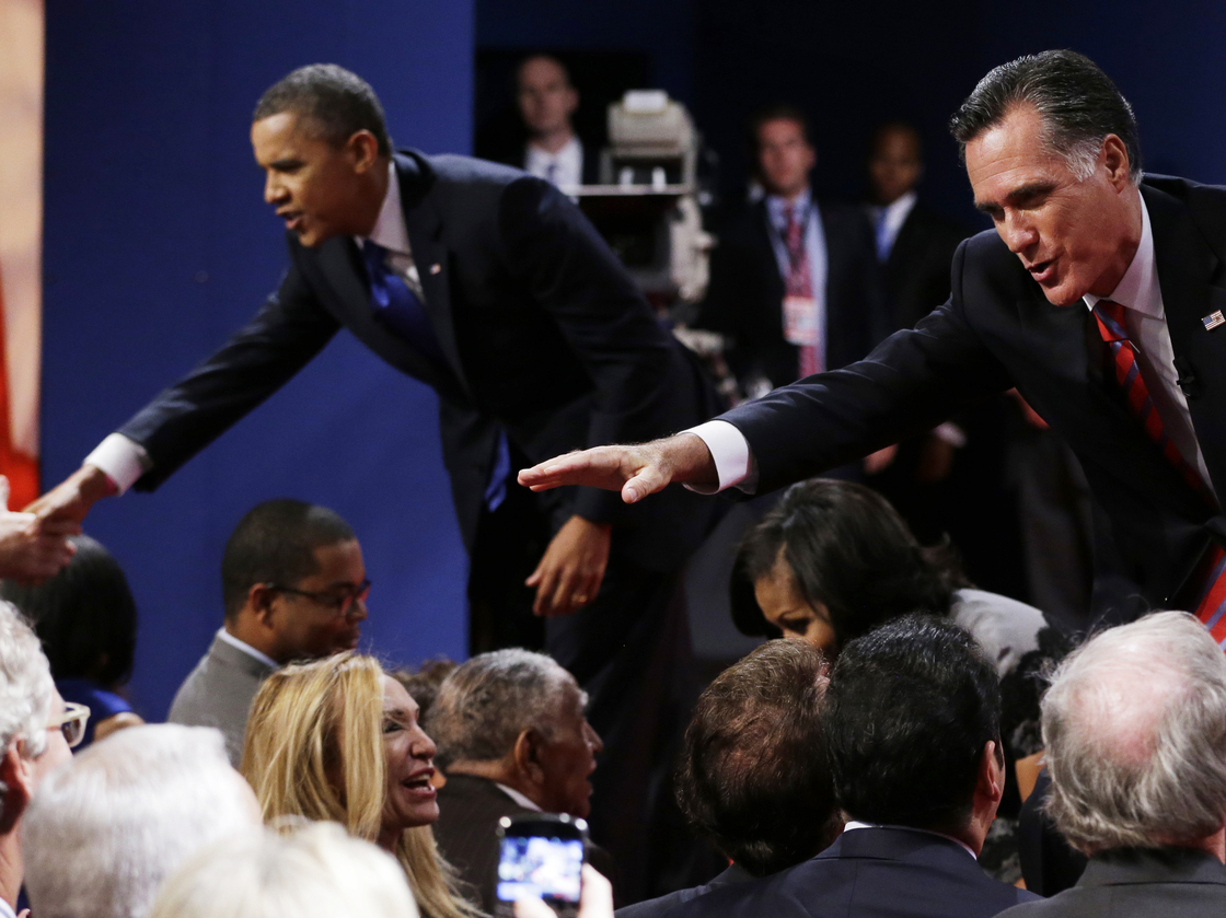Republican presidential nominee Mitt Romney and President Obama shake hands with audience members following the third presidential debate Monday at Lynn University in Boca Raton, Fla.