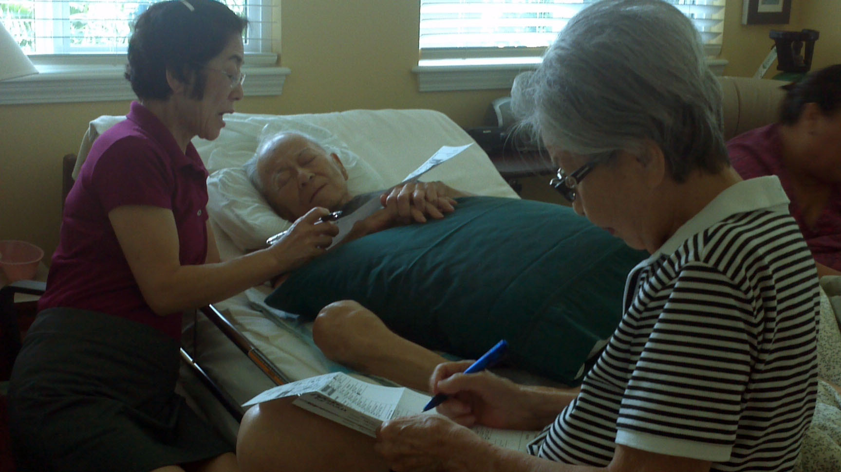 Oct. 17: Frank Tanabe, center, casts his vote with help from his daughter Barbara Tanabe, left, and his wife Setsuko Tanabe. Oct. 17: Frank Tanabe, center, casts his vote with help from his daughter Barbara Tanabe, left, and his wife Setsuko Tanabe.