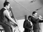 Bassist Charles Mingus leads a band at the 1964 Monterey Jazz Festival, including Lonnie Hillyer (trumpet) and Charles McPherson (alto sax, obscured).