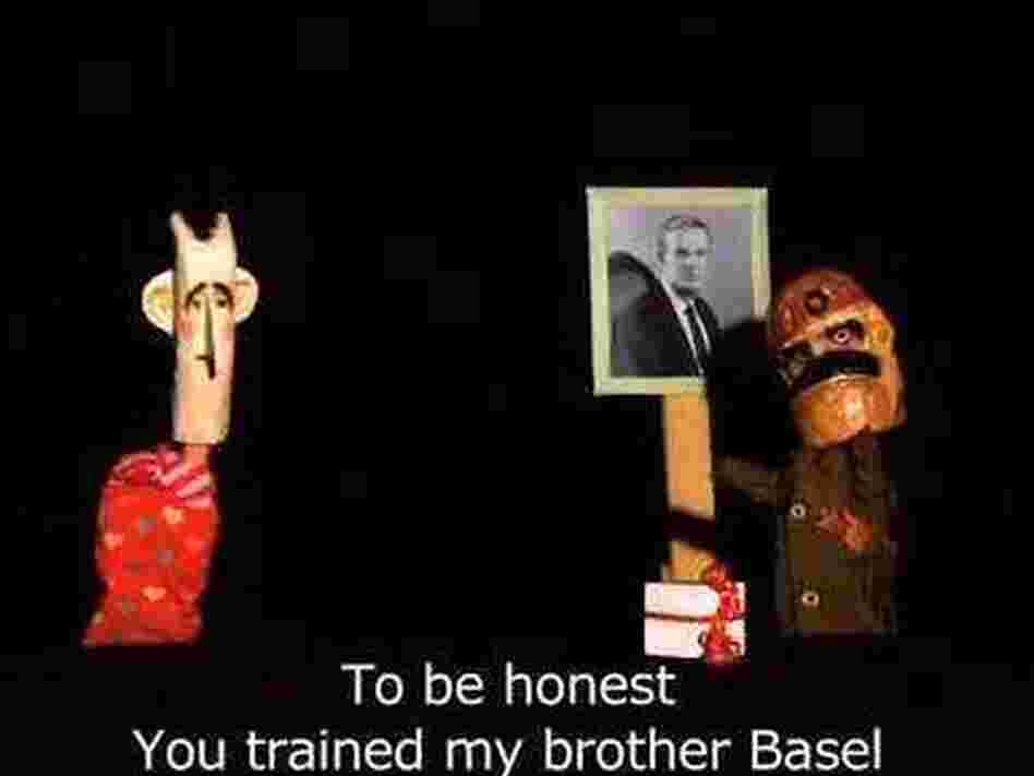 This episode of Top Goon featured the Syrian president on the left, a member of the security forces on the right, and a photo of the former president, Hafez Assad, who is the father of the current leader. This episode of Top Goon featured the Syrian president on the left, a member of the security forces on the right, and a photo of the former president, Hafez Assad, who is the father of the current leader.