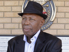 Alf Kumalo, a celebrated South African photographer, died Sunday of prostate cancer in Soweto. He was 82. Here, he is seen in April outside the Magistrate Court in Johannesburg, while pursuing a hate speech case against a white man he accused of attacking him with a racial slur. Alf Kumalo, a celebrated South African photographer, died Sunday of prostate cancer in Soweto. He was 82. Here, he is seen in April outside the Magistrate Court in Johannesburg, while pursuing a hate speech case against a white man he accused of attacking him with a racial slur.
