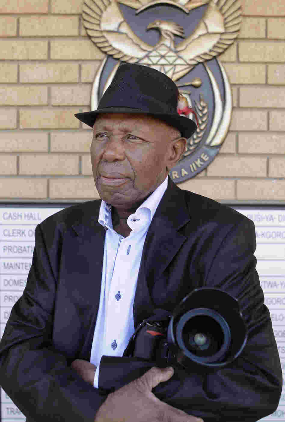 Alf Kumalo, a celebrated South African photographer, died Sunday of prostate cancer in Soweto. He was 82. Here, he is seen in April outside the Magistrate Court in Johannesburg, while pursuing a hate speech case against a white man he accused of attacking him with a racial slur.