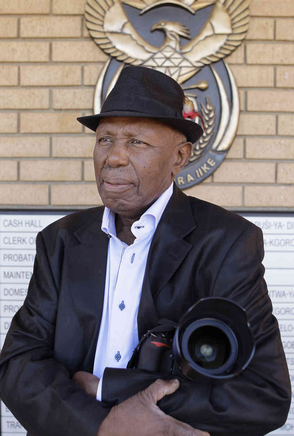 Alf Kumalo, a celebrated South African photographer, died Sunday of prostate cancer in Soweto. He was 82. Here, he is seen in April outside the Magistrate Court in Johannesburg, while pursuing a hate speech case against a white man he accused of attacking him with a racial slur.