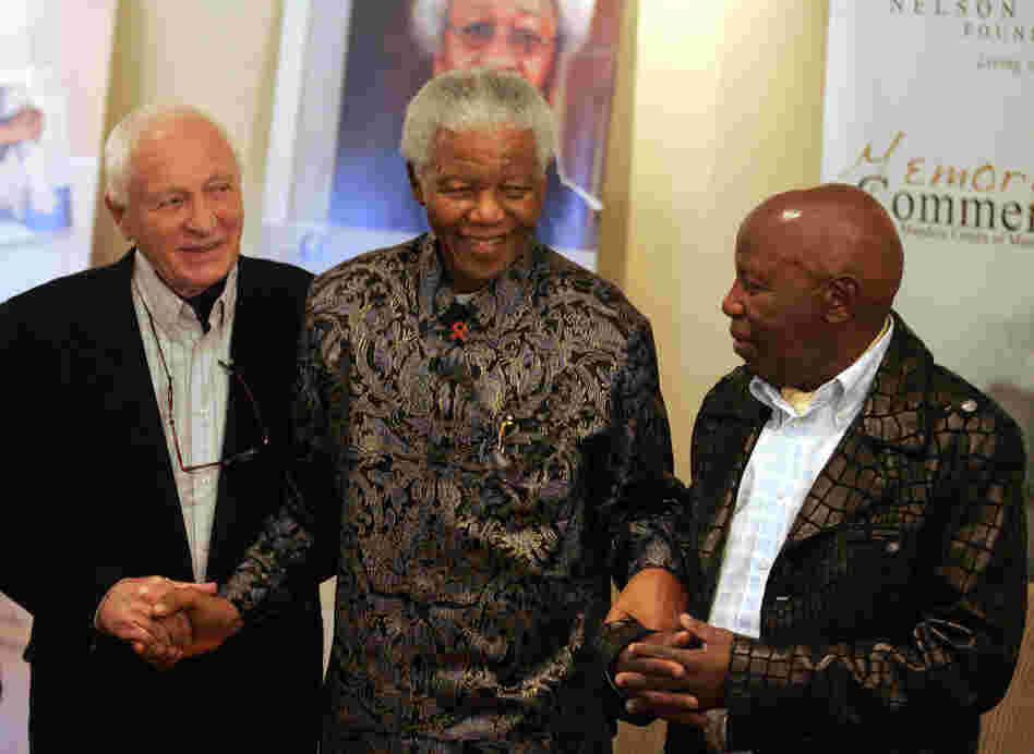 Kumalo stands with former South African President Nelson Mandela and photographer Jurgen Schadeberg during the launch of a photo exhibition at the Nelson Mandela Foundation in Johannesburg, July 12, 2006. Kumalo photographed Mandela and his family extensively throughout his career.