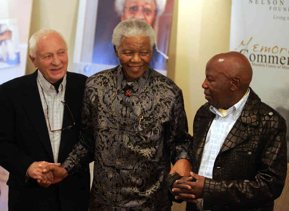 Kumalo stands with former South African President Nelson Mandela and photographer Jurgen Schadeberg during the launch of a photo exhibition at the Nelson Mandela Foundation in Johannesburg, July 12, 2006. Kumalo photographed Mandela and his family extensively throughout his career.