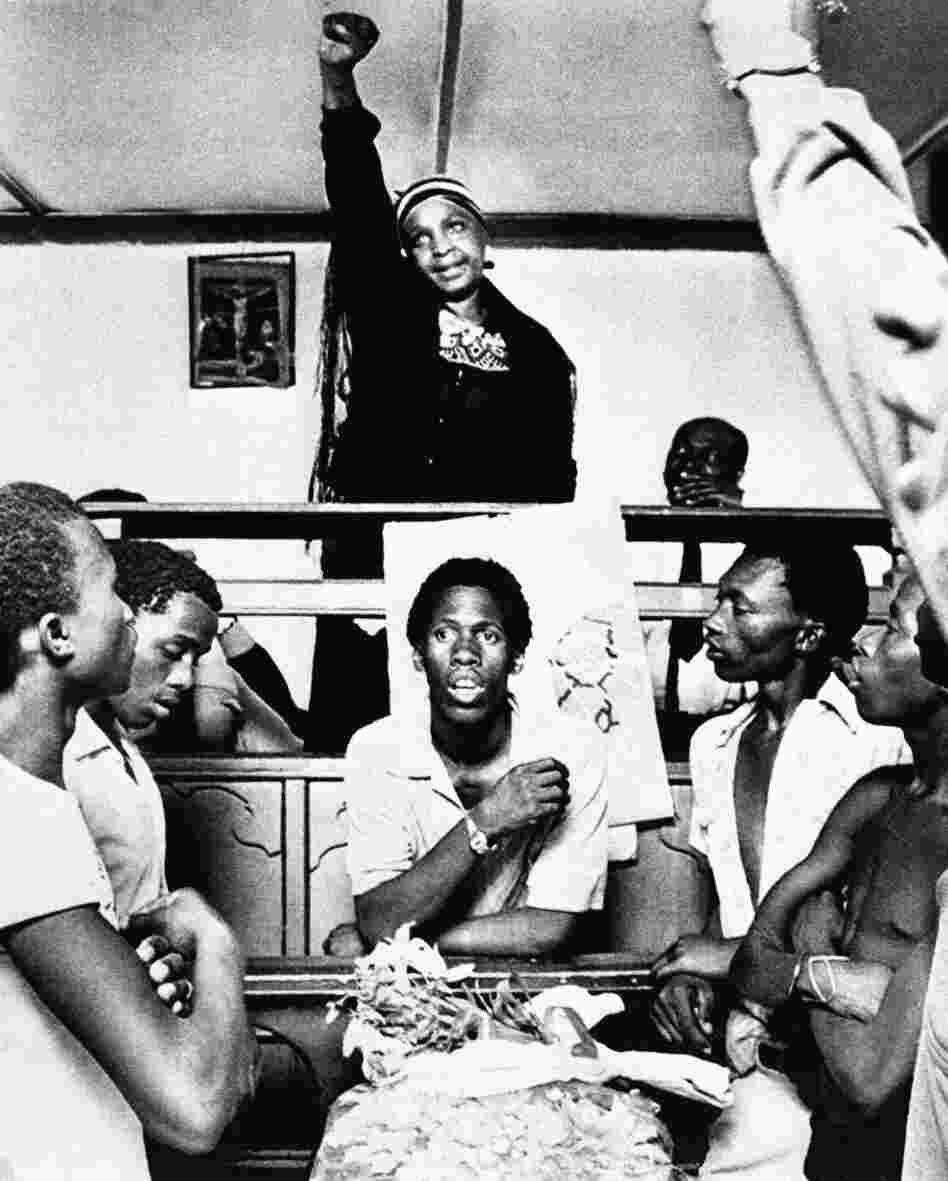 Winnie Mandela, the then-wife of Nelson Mandela, attends the funeral of a 19-year-old who was stabbed to death by a prison warden in the tiny town of Brandfort, South Africa, on Nov. 23, 1985, while her husband was taken back to jail from a hospital in Cape Town. She made a political speech and gave the black power salute while youths sang freedom songs.