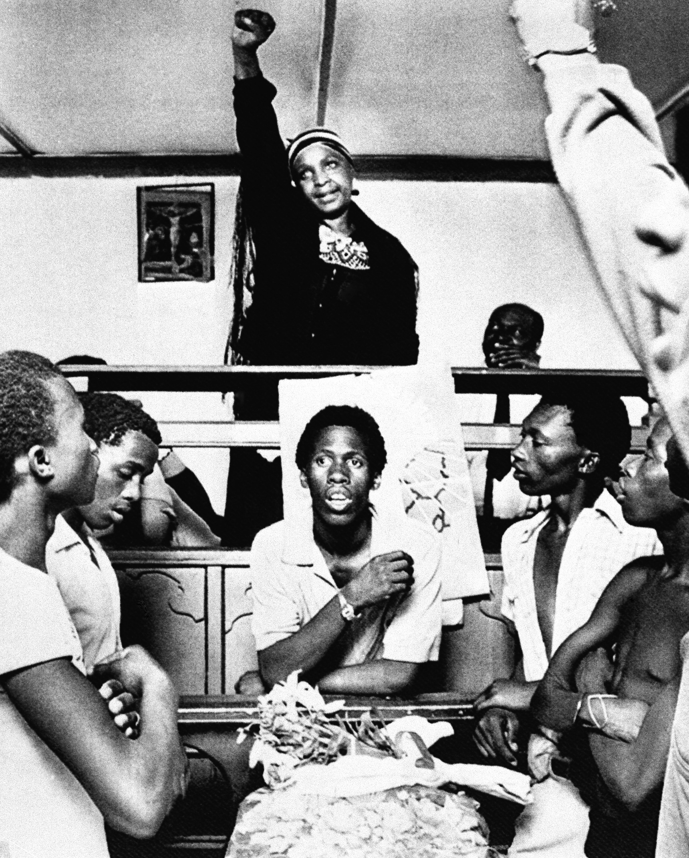 Winnie Mandela, the then-wife of Nelson Mandela, attends the funeral of a 19-year-old who was stabbed to death by a prison warden in the tiny town of Brandfort, South Africa, on Nov. 23, 1985, while her husband was taken back to jail from a hospital in Cape Town. She made a political speech and gave the black power salute while youths sang freedom songs.