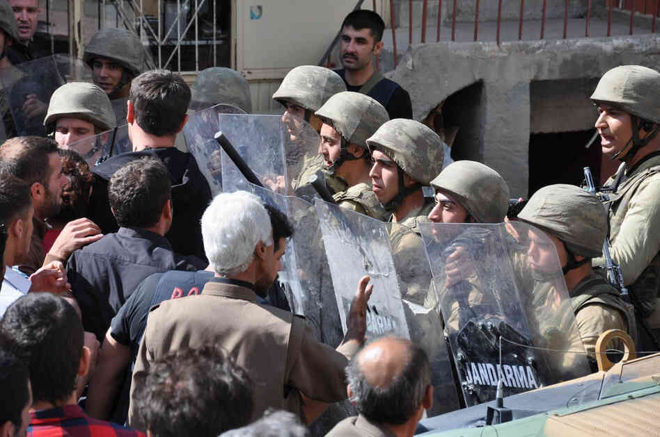 Turkish soldiers block a street as Kurds demonstrate on September 3 in the center of Beytussebap, about 25 miles from the Iraqi border.
