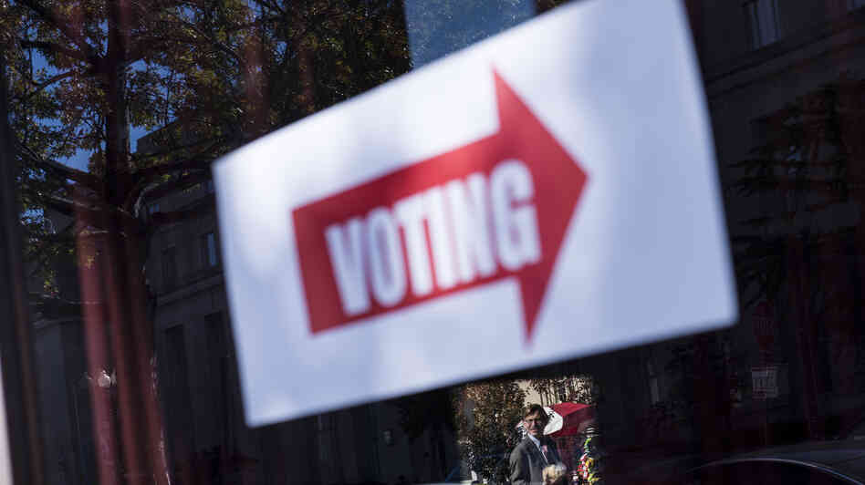 A sign directing voters to a polling place is seen during the first day of early voting on Monday in Washington, D.C.