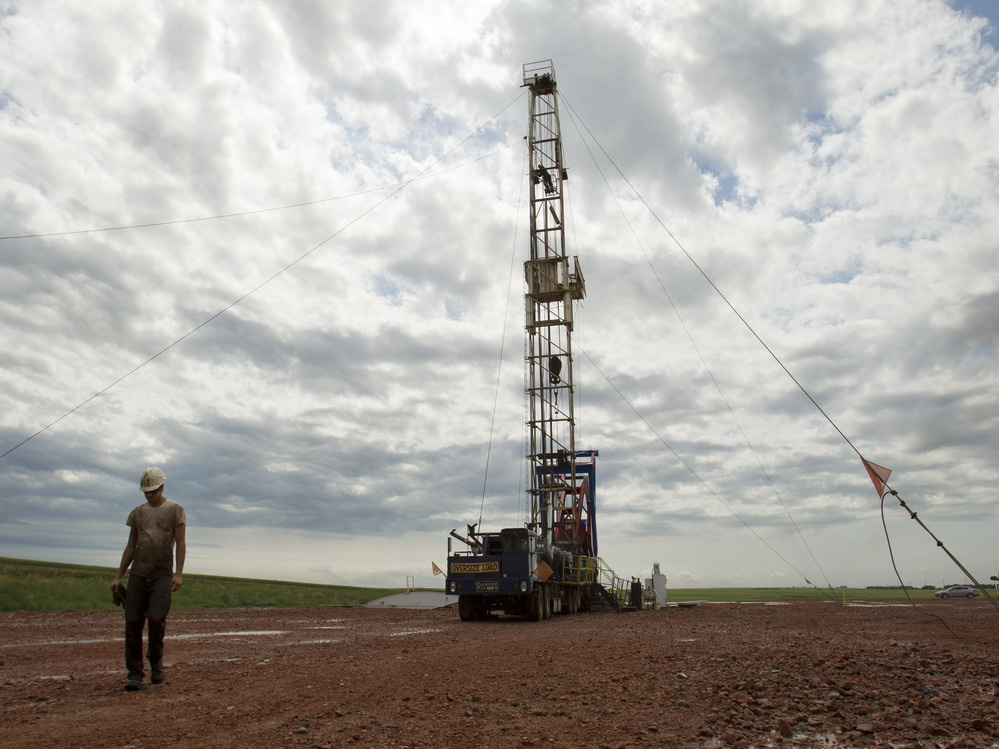Austin Mitchell walks away from an oil derrick outside Williston, N.D., in July 2011. North Dakota is now the No. 2 producer of oil in the U.S. behind Texas.