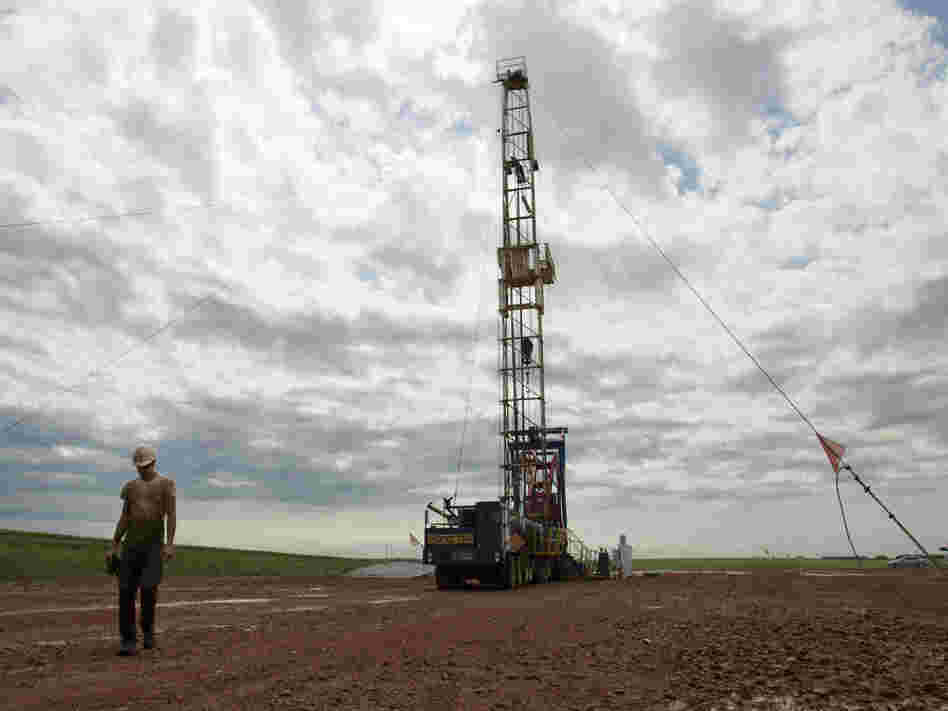 Austin Mitchell walks away from an oil derrick outside Williston, N.D., in July 2011. North Dakota is now the No. 2 producer of oil in the U.S. behind Texas.